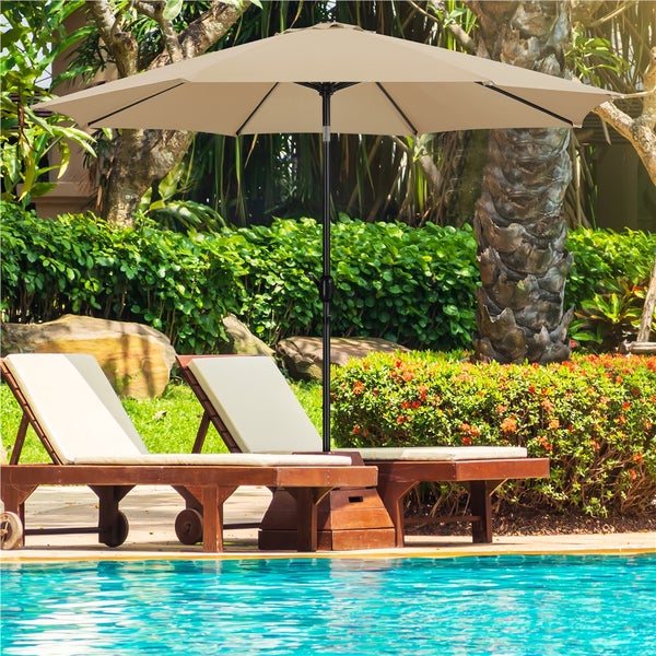 Szene mit zwei Liegestühlen, einem Sonnenschirm und einem Schwimmbad im Hintergrund.