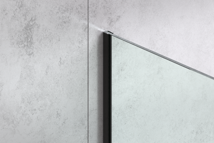 Glas-Duschwand mit schwarzem Profil an einer Wand in Betonoptik.