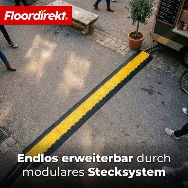 Modulare Kabelbrücke mit Stecksystem zum Schutz von Leitungen auf einem Gehweg im Außenbereich. Floordirekt Logo.