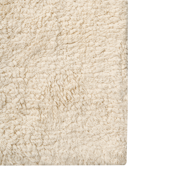 Beigefarbener Hochflor-Teppich mit weicher, gelockter Textur.