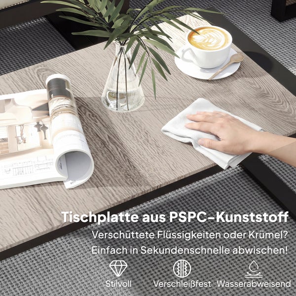 Eine Hand reinigt eine Tischplatte aus PSPC-Kunststoff in Holzoptik. Die Oberfläche ist verschleißfest, wasserabweisend und pflegeleicht.