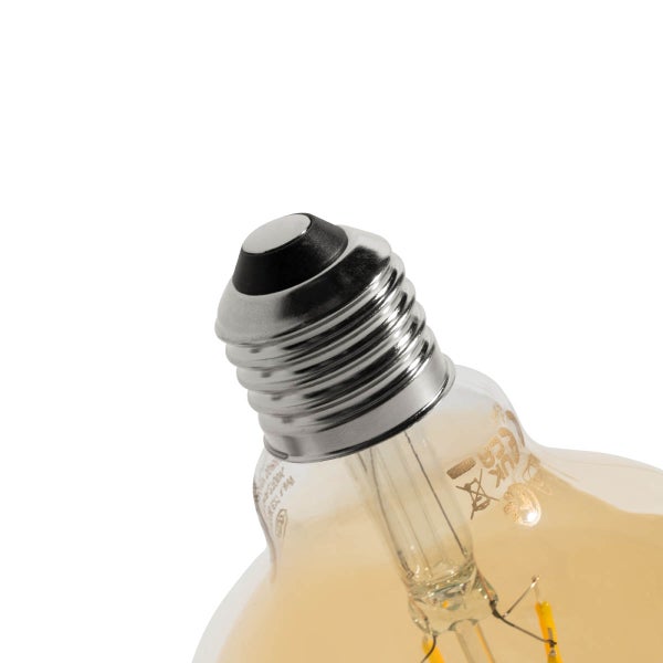 Nahaufnahme eines E27 Schraubsockels einer LED-Filamentlampe mit bernsteinfarbenem Glas und technischen Details.