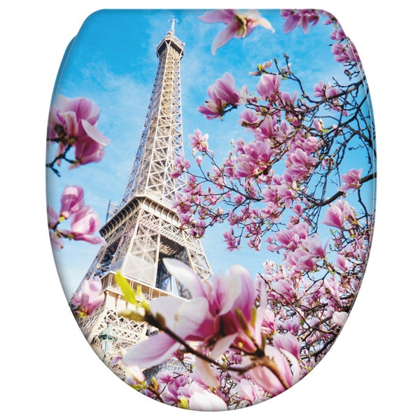 Toilettensitz mit aufgedrucktem Eiffelturm und Magnolienblüten vor blauem Himmel