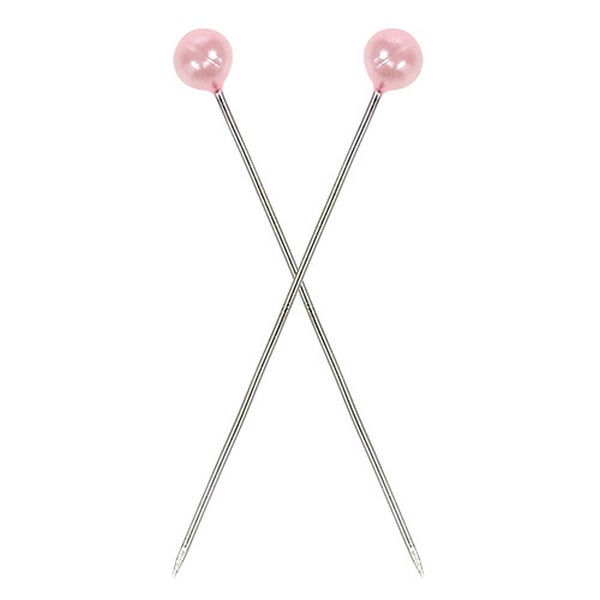 Zwei Stecknadeln mit runden Köpfen kreuzen sich