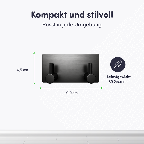 Schwarzer Wandhaken mit zwei Haken, Abmessungen 4,5 mal 9,0 Zentimeter, Gewicht 89 Gramm, Symbol für geringes Gewicht.