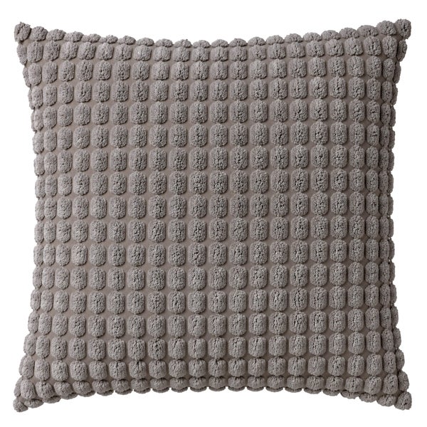 Quadratisches Zierkissen mit strukturierter Noppenoberfläche aus Textil für Wohnzimmer oder Schlafzimmer.