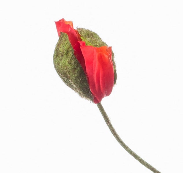Künstliche Blume mit weißen Blüten und grünen Blättern.