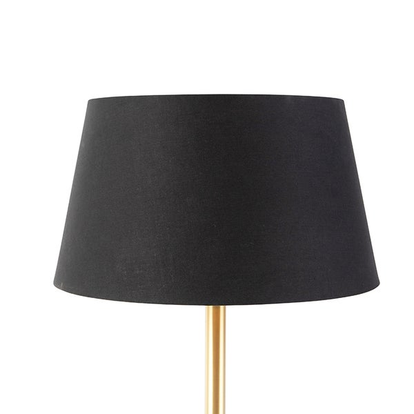 Konischer Lampenschirm aus schwarzem Stoff auf einem goldfarbenen Staender.