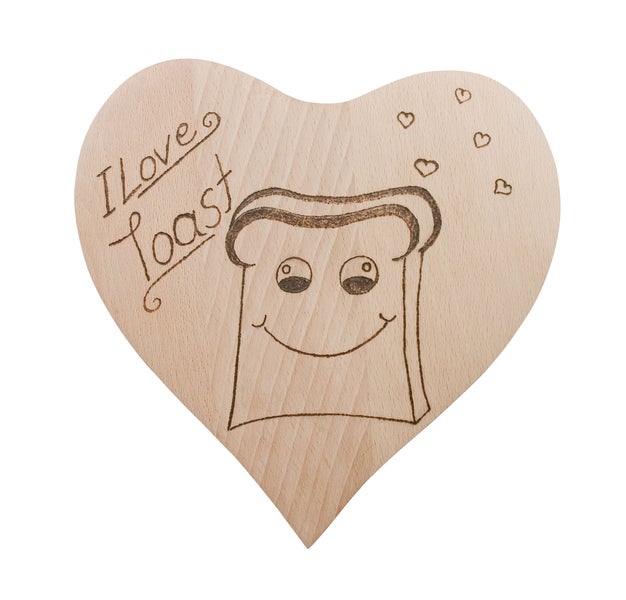 Herzförmiges Holzbrett mit Brandmalerei eines Toastbrots und der Aufschrift I love Toast