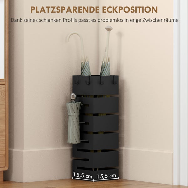 Schwarzer Schirmständer aus Metall im quadratischen Design, platzsparend in einer Zimmerecke aufgestellt. Maße 15,5 mal 15,5 Zentimeter.