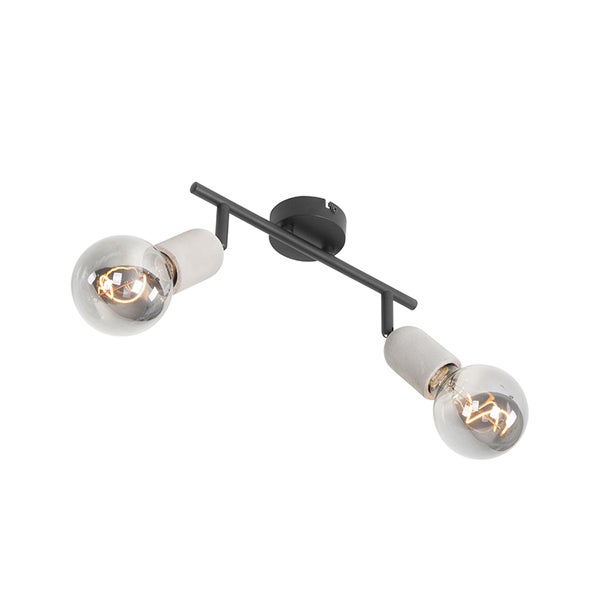Zweiflammiger Deckenstrahler mit schwarzem Metallgestell, Fassungen in Beton-Optik und sichtbaren Leuchtmitteln im Industriedesign.