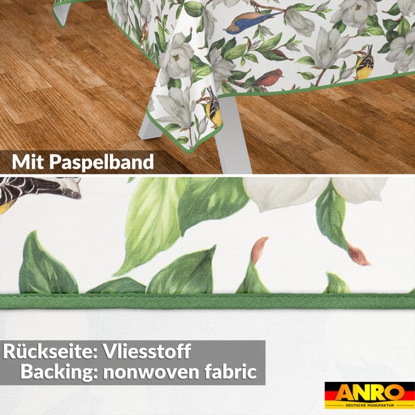 Tischdecke mit Blumen- und Vogelmuster, Paspelband und Vliesstoff-Rückseite. ANRO Logo.