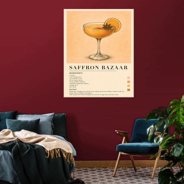 Wandbild mit Saffron Bazaar Cocktail Rezept Illustration über einem Bett mit dunkelgrüner Decke und einem blauen Sessel im Schlafzimmer.