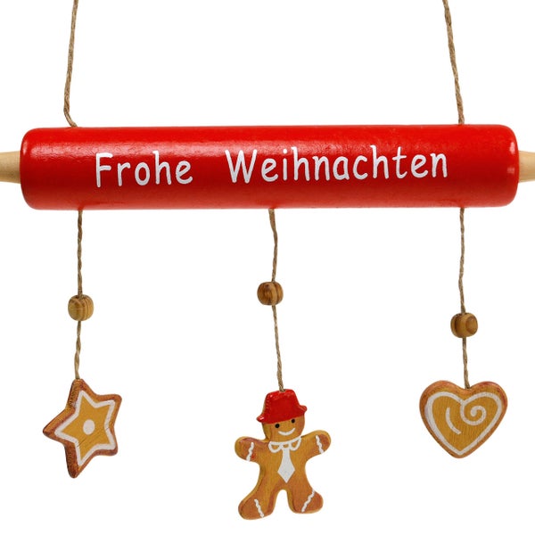 Weihnachtsdekoration mit der Aufschrift Frohe Weihnachten und Anhängern in Form von Stern, Lebkuchenmann und Herz