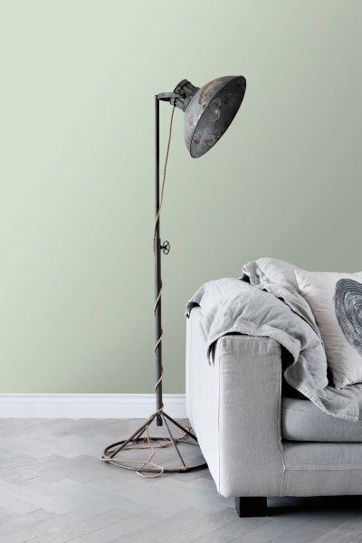 Stehlampe aus Metall neben einem Sofa