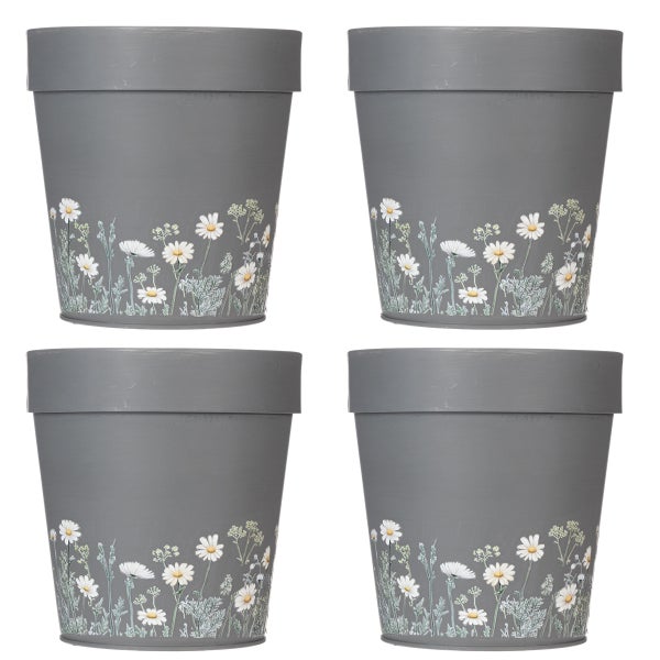 Grauer Blumentopf aus Metall mit weißem Gänseblümchen-Muster am Boden.