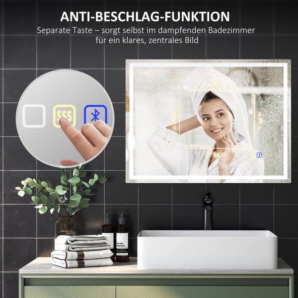 Badezimmerspiegel mit Beleuchtung, Anti-Beschlag-Funktion und Bluetooth, modernes Bad mit schwarzen Fliesen, weißem Waschbecken und Touch-Bedienung.
