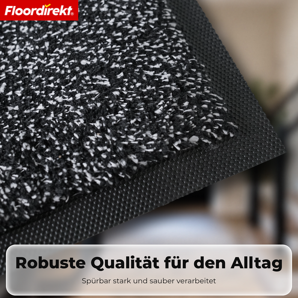 Floordirekt Logo. Detailansicht einer robusten Schmutzfangmatte mit rutschfestem Rand für den täglichen Gebrauch.