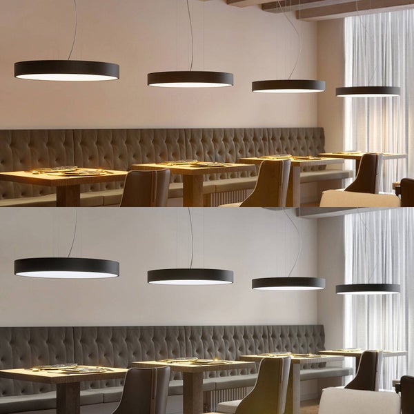 Moderner Essbereich mit runden schwarzen LED-Pendelleuchten über Holztischen. Vergleich von warmweißem und neutralweißem Licht.