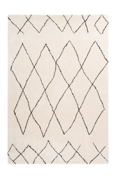 Rechteckiger Hochflor-Teppich in Creme mit schwarzem Rautenmuster, weiche Textur.