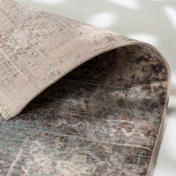 Detailansicht eines gemusterten Teppichs im Vintage-Stil mit Darstellung von Flor und Rückseite.