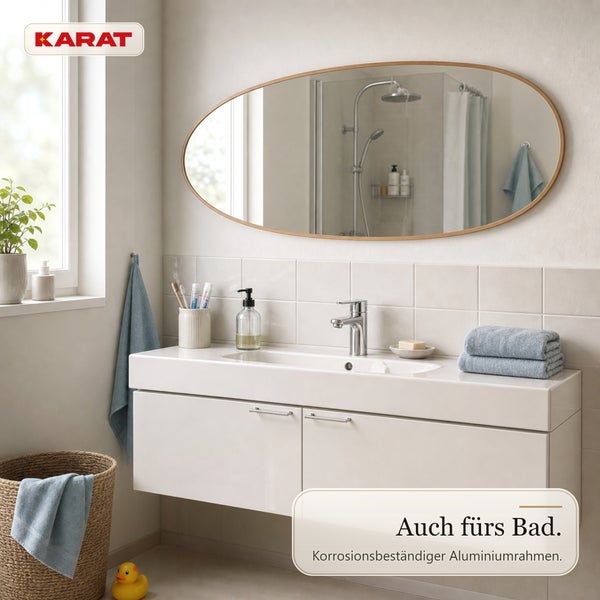 Karat Logo und ovaler Badezimmerspiegel mit Aluminiumrahmen über einem Waschbecken in modernem, hellem Badezimmer mit Fliesen.