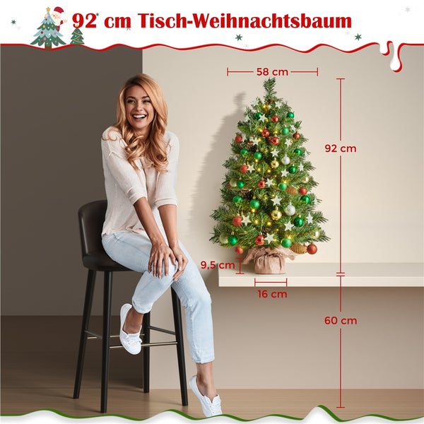 92 Zentimeter Tischweihnachtsbaum mit Kugeln und Sternen auf einem Tisch