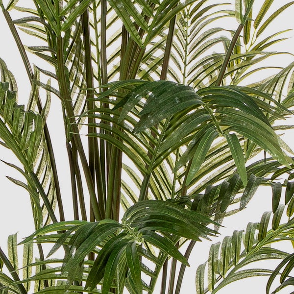 Künstliche Palme im schwarzen Topf mit grünen Wedeln.