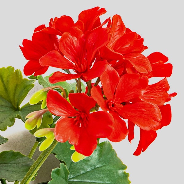 Künstliche Dahlie in Rosa mit zwei Blüten, einer Knospe und grünen Blättern.