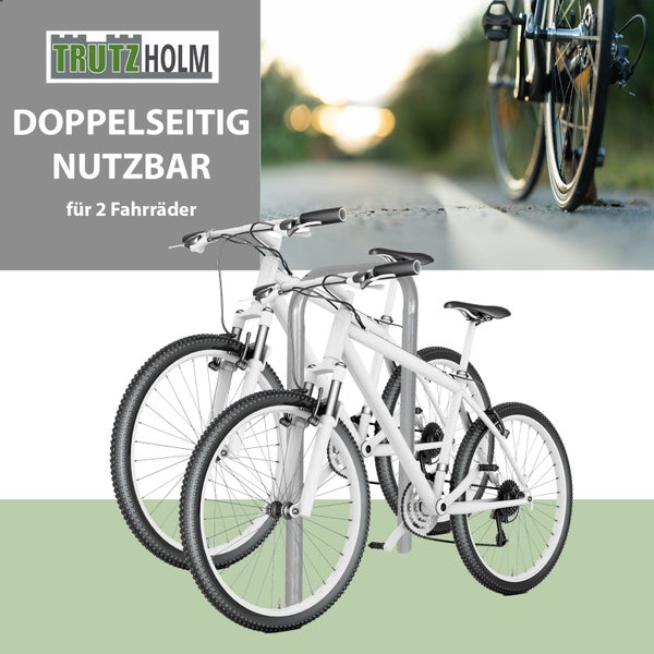 Trutzholm Logo, doppelseitiger grauer Fahrradständer aus Metall für zwei Fahrräder.