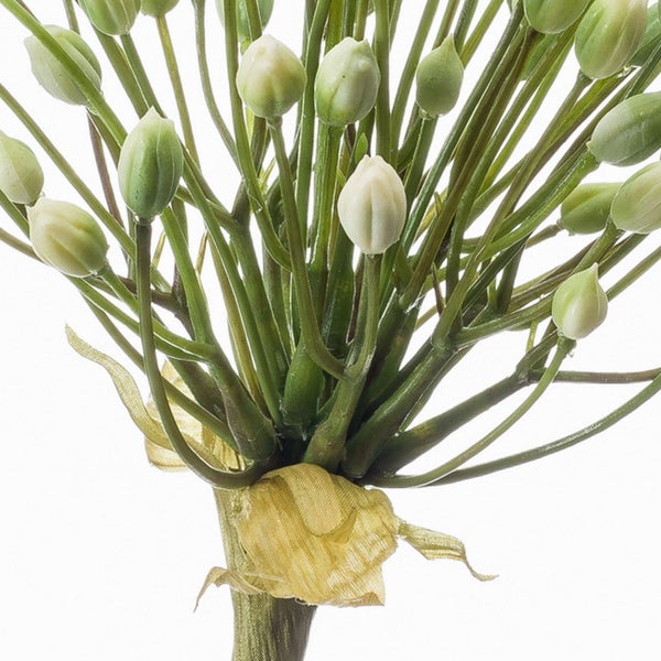 Künstliche Pflanze mit cremefarbenen Knospen und gelbem Band.