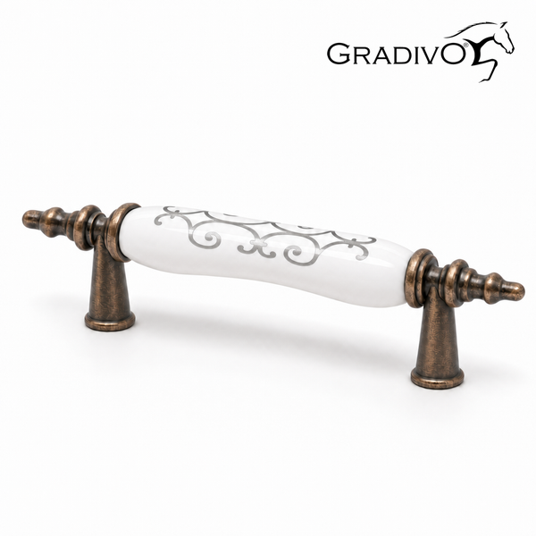 Gradivo Möbelgriff aus bronzefarbenem Metall und weißem Porzellan mit Ornamenten.