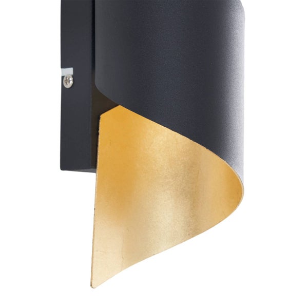 Moderne Wandleuchte aus Metall mit geschwungenem Schirm, schwarze Außenseite und goldfarbene Innenseite.