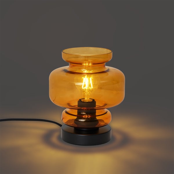Bernsteinfarbene Glas Tischleuchte mit Glühbirne auf schwarzem Sockel