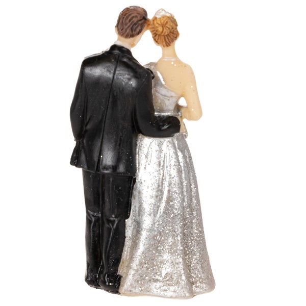 Brautpaar-Figur als Tortenaufsatz, Rückansicht eines Paares in schwarzem Anzug und glitzerndem Kleid.