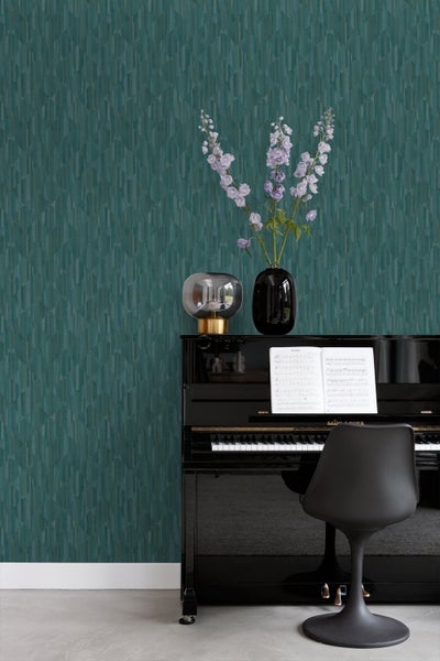 Wohnzimmer mit gemusterter Tapete, Lampe, Blumen und Klavier