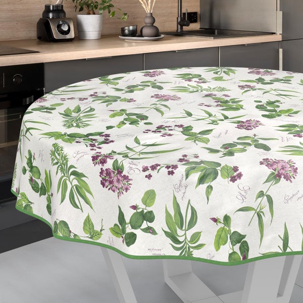 Runde Tischdecke mit botanischem Blatt- und Blütenmuster auf einem Tisch in einer modern eingerichteten Küche.