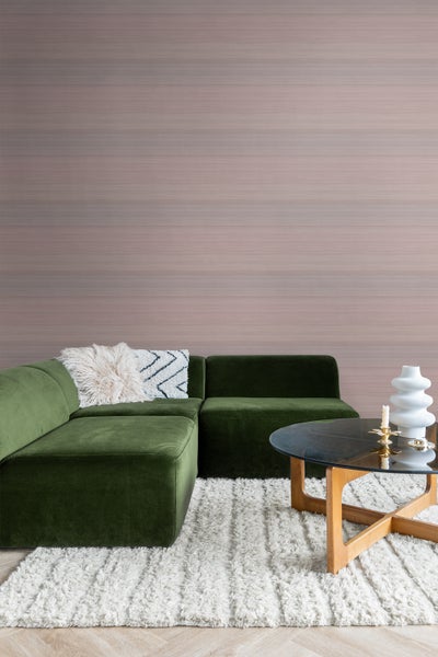 Wohnzimmer mit grünem Sofa, Teppich und Couchtisch