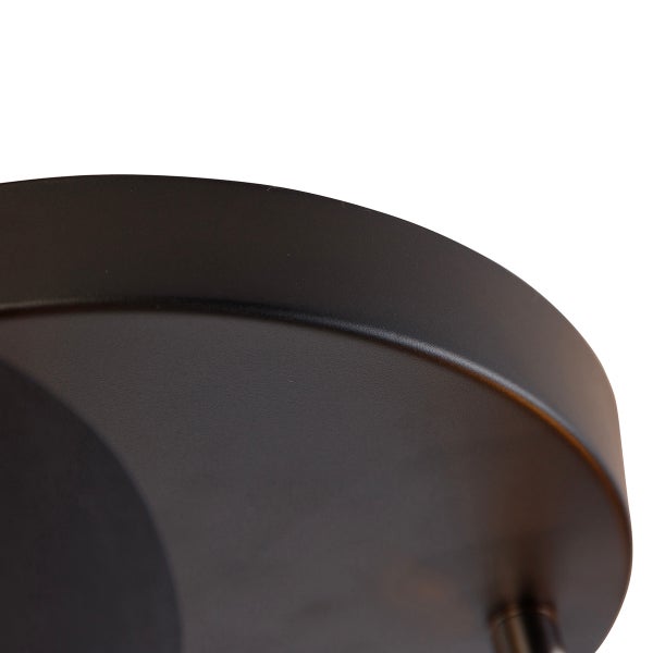 Detailaufnahme eines runden, mattschwarzen Metallbaldachins für eine Leuchte.