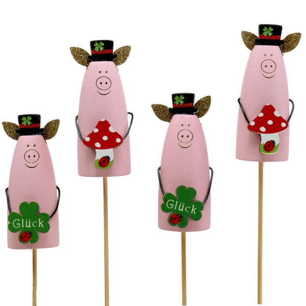 Vier Glücksschweine als Dekoration für den Garten