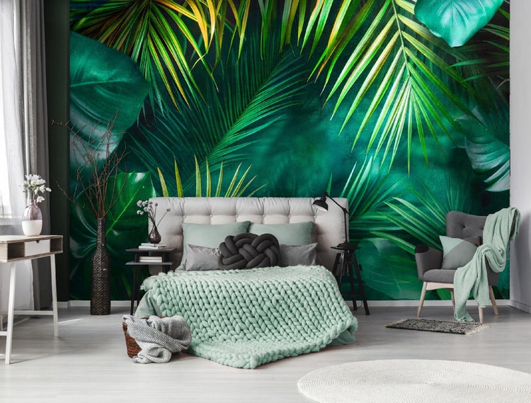 Schlafzimmer mit Dschungeltapete, Bett, Sessel und Dekoration