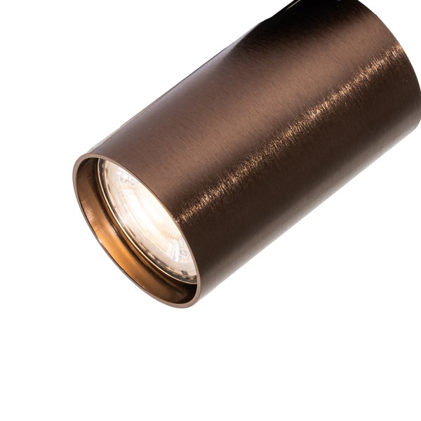 Zylindrischer Strahler aus gebürstetem Metall mit eingeschaltetem Leuchtmittel.