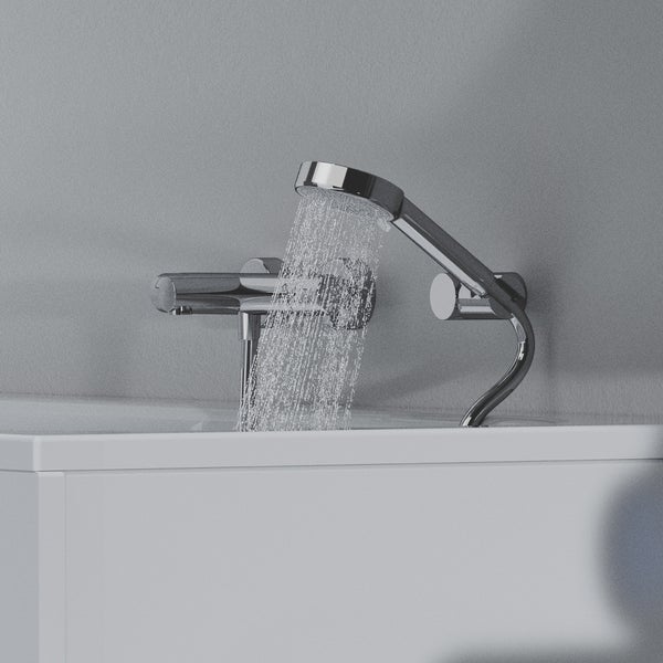 Wannenrandarmatur mit Handbrause aus Metall, Wasserstrahl fließt in die Badewanne