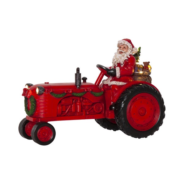 Weihnachtsdekoration: Santa Claus auf rotem Traktor mit Beleuchtung