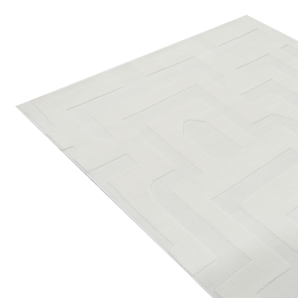 Ein moderner Teppich mit geometrischem Reliefmuster und strukturierter Oberfläche in rechteckiger Form.