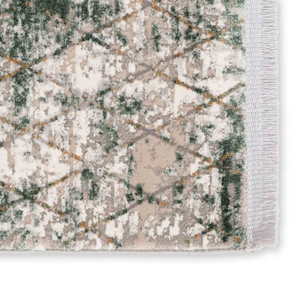 Nahaufnahme eines Teppichs mit abstraktem Muster und Fransen an der Kante.