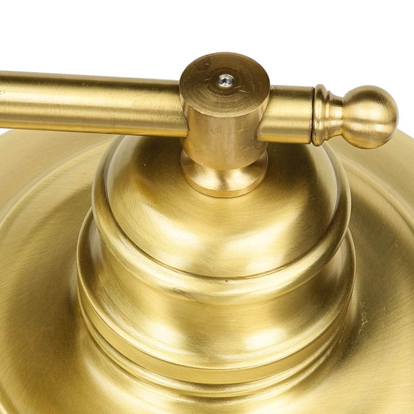 Detailansicht einer goldenen Lampe mit Arm und Gelenk