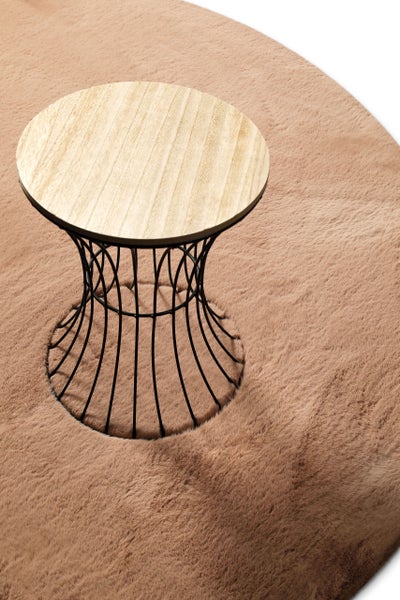 Kleiner runder Beistelltisch mit Holzplatte und schwarzem Metalldrahtgestell auf einem weichen Kunstfellteppich.