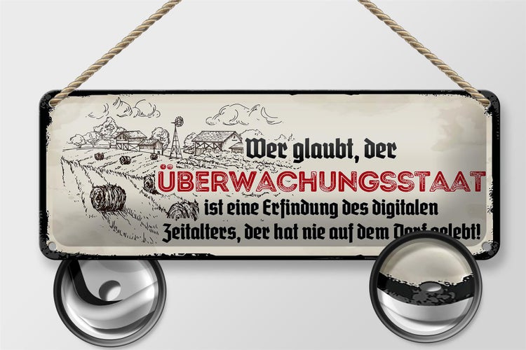 Blechschild Spruch 27x10cm Überwachungsstaat Dorf Dekoration