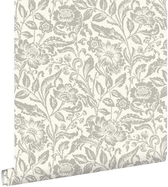 Vlies-Tapete mit großflächigem floralem Muster aus Blumen und Blättern.